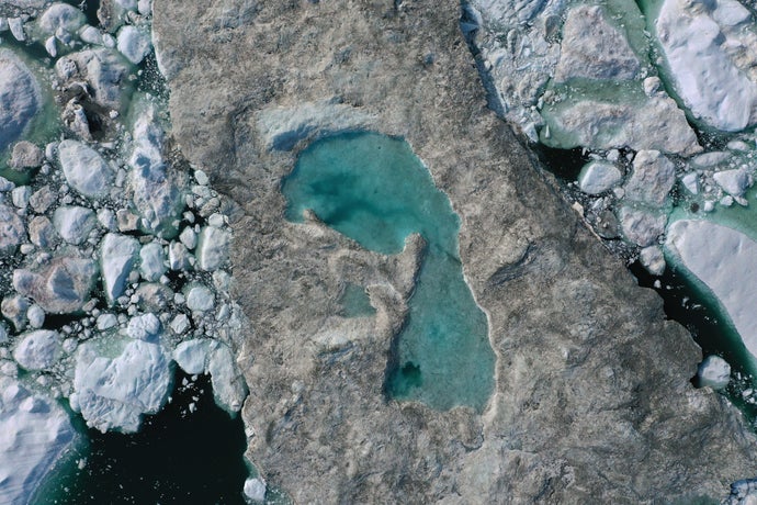 ice forms a lake on free-floating ice jammed into the Ilulissat Icefjord